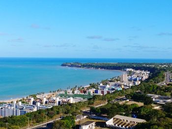 High angle view of sea and cityscape against sky