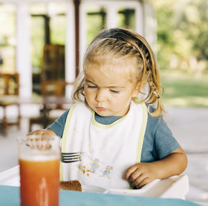 Cute girl sitting on table