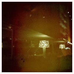 Illuminated sign on street against building at night