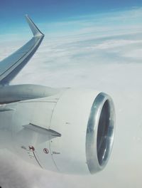 Close-up of airplane wing against sky