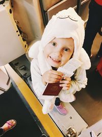 Portrait of a smiling girl holding camera