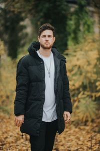 Young man standing in forest