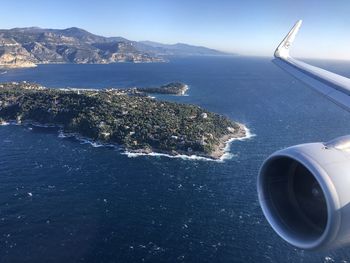 Aerial view of sea and mountains against sky