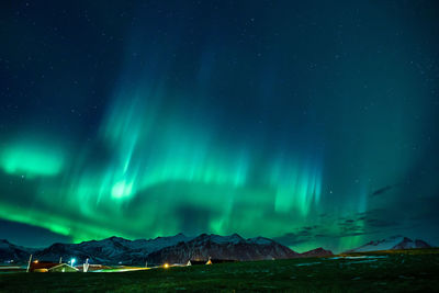 Scenic view of snowcapped mountains against sky at night