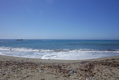 Scenic view of sea against clear blue sky