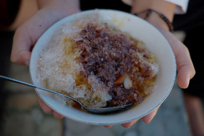 Close-up of hand holding ice cream