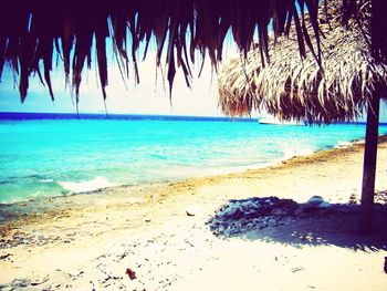 Scenic view of beach against blue sky