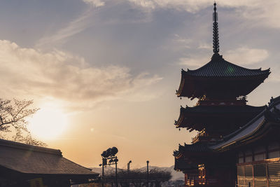 Low angle view of pagoda against sky during sunset