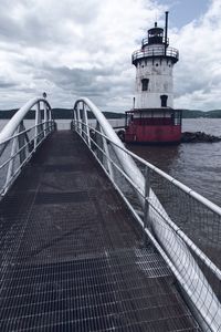 View of pier on sea against cloudy sky