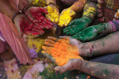 Close-up of hands holding powder paint