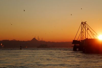 Scenic view of sea against orange sky