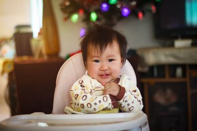 Close-up of cute girl using mobile phone at home