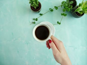 Midsection of person holding coffee cup