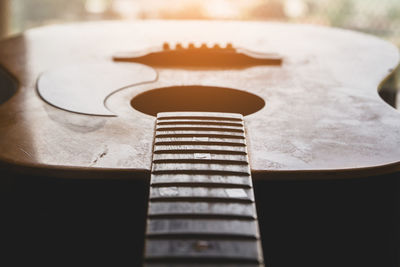 Close-up of guitar on table