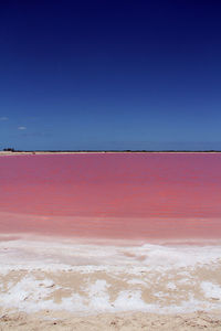 Scenic view of sea against blue sky