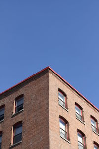 Low angle view of building against clear blue sky