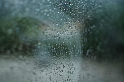 Full frame shot of wet glass window during rainy season