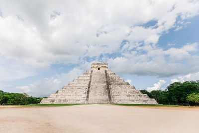 Low angle view of historical building against cloudy sky