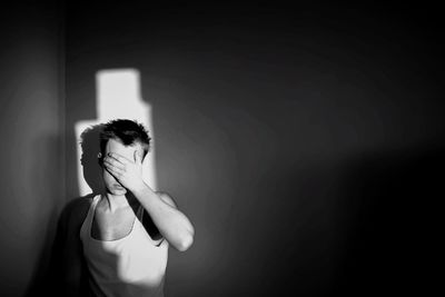 Young woman standing against white background