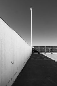 The top level of a empty office complex parking garage against a blue sky taken one quiet sunday