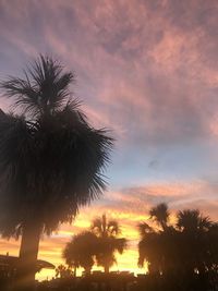 Low angle view of silhouette palm trees against sky during sunset
