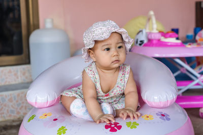 Cute baby girl sitting on table