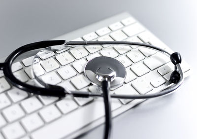 High angle view of stethoscope on computer keyboard