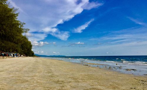 View of beach against cloudy sky