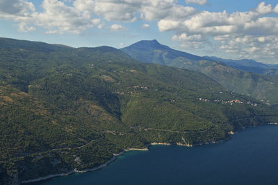 Scenic view of sea and mountains against sky