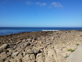 Scenic view of sea against blue sky