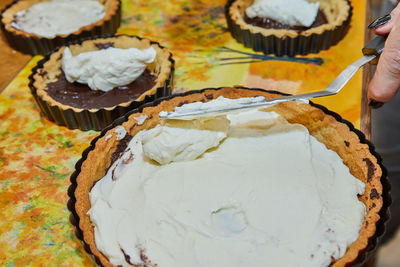 Manufacturing process round cream pie with chocolate and strawberries. french recipe