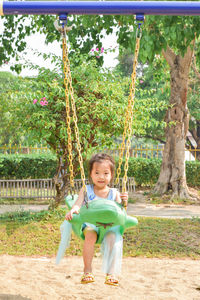 Portrait of a smiling girl on swing