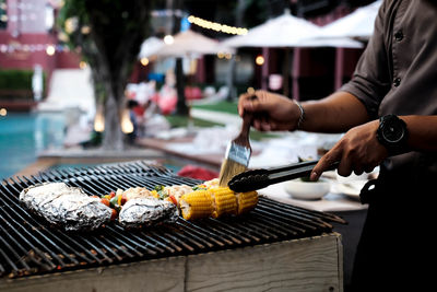 Man preparing food on barbecue grill