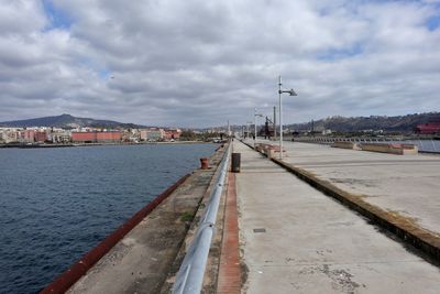 City street by sea against sky