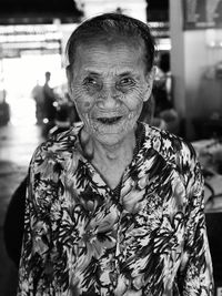 Portrait of mid adult woman against blurred background