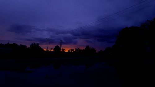 Silhouette of trees against sky at dusk