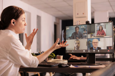 Side view of business colleagues working in office