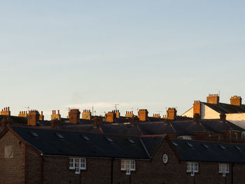 Houses in city against sky