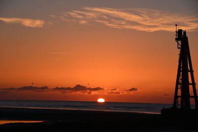 Scenic view of sea against orange sky