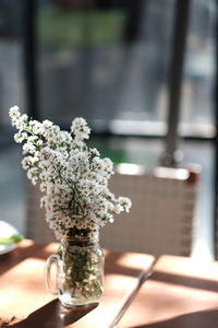 Close-up of white flower vase on table