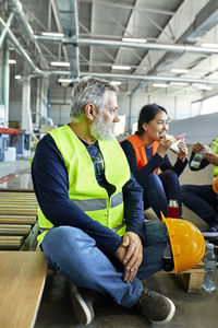 Workers in factory having lunch break together