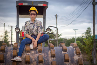 Portrait of female architect sitting on bulldozer