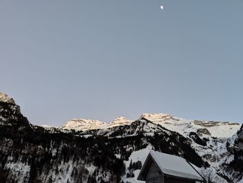 Scenic view of snowcapped mountains against clear sky