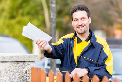 Portrait of a smiling young man standing outdoors