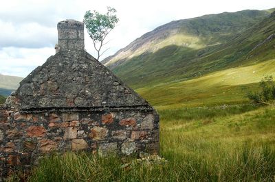 Stone wall against mountain range
