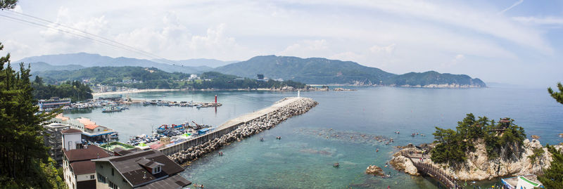 Panoramic view of sea and mountains against sky