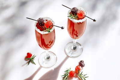 Christmas mimosa punch or cranberry margarita cocktail with orange liqueur and champagne.