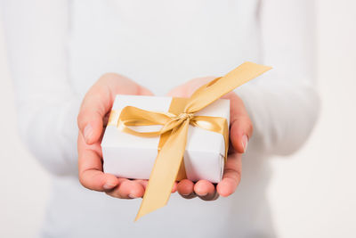 Midsection of woman holding gift