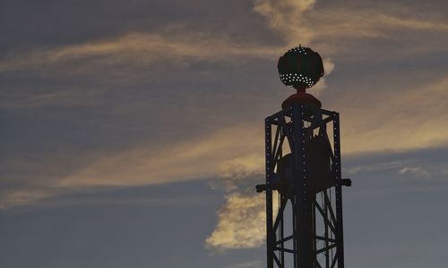 Low angle view of communications tower against sky during sunset