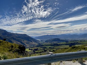 Road leading towards mountains against sky